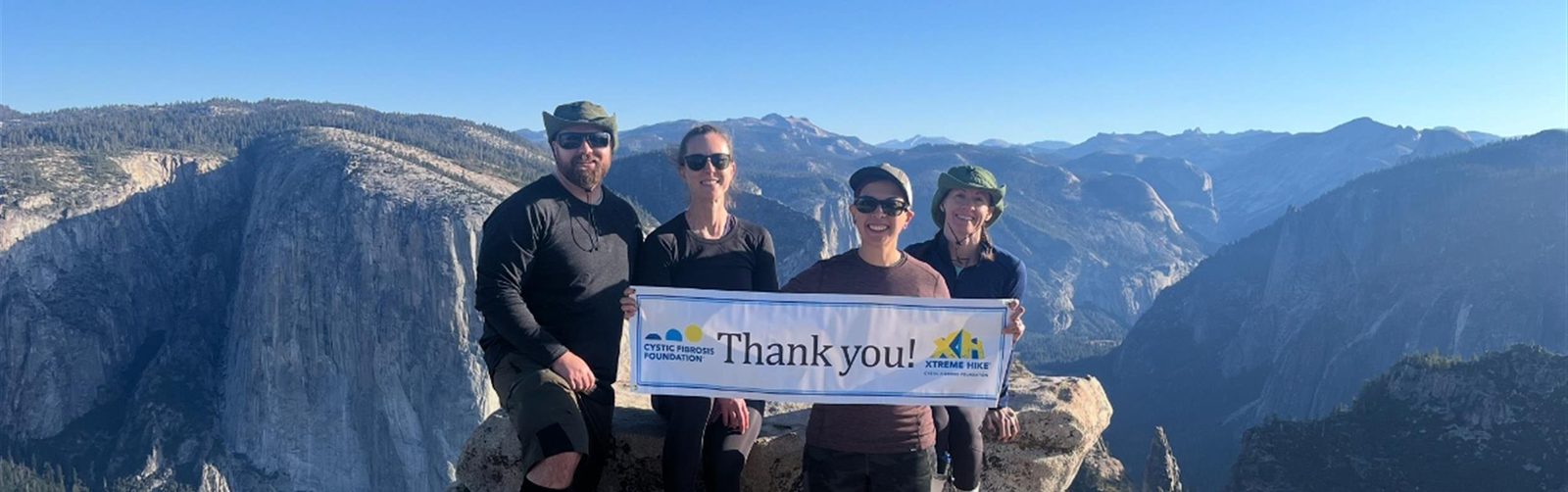 Team Super Shea at Yosemite holding a Cystic Fibrosis Foundation Thank You banner